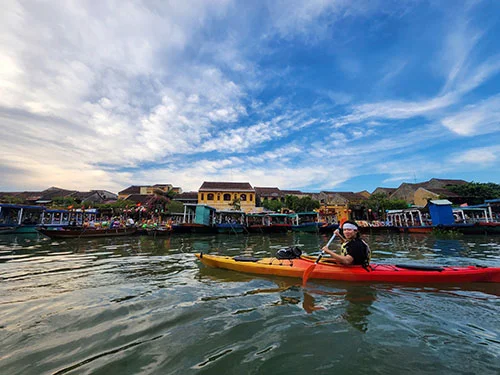 Young man entering Hoian Old Town in his kayak