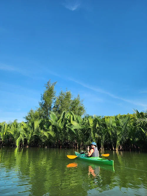 One young tourist rowing their layal over the calm waters of the river