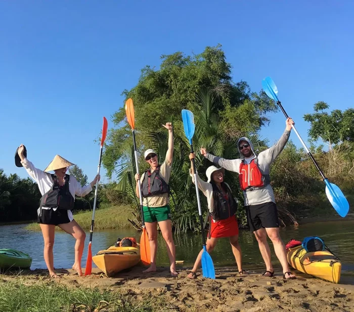 Kayak rental vessels and their happy travelers on shore