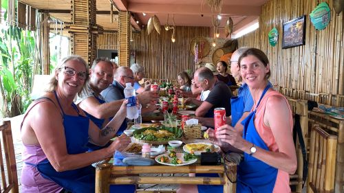 Grouo of people enjoy meal after cooking class