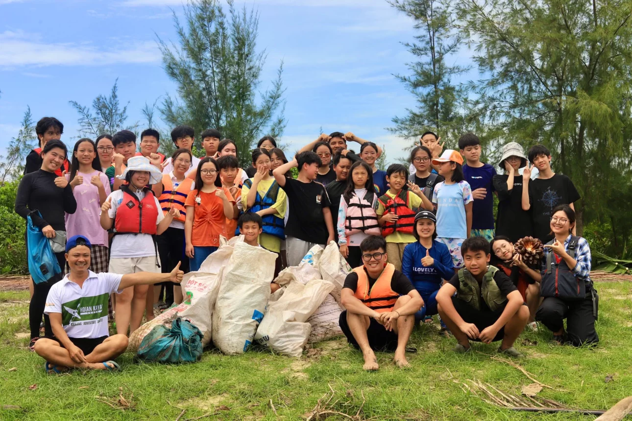 happy schoolers posing after a river cleanup trip